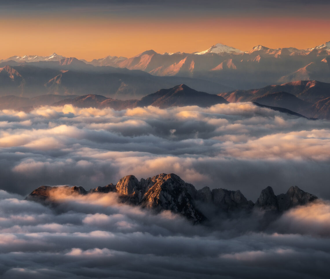 Il tramonto accende un paesaggio alpino autunnale già pronto a infiammarsi. Alpi Giulie, Carniche e Alti Tauri. Italia.