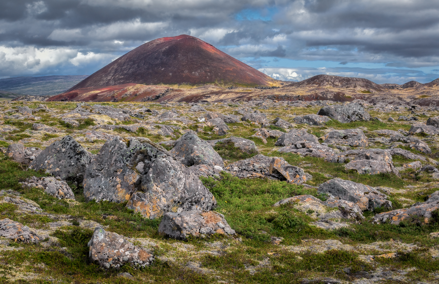 Piccoli crateri rossi si innalzano da antichi campi di lava oggi totalmente trasformati. Variopinte testimonianze di un passato burrascoso. Islanda.