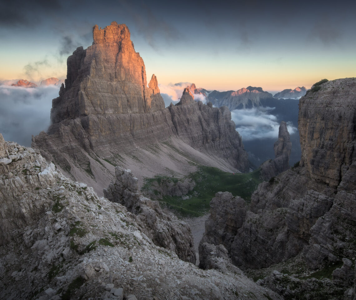 Al tramonto le nuvole si diradano, lasciando spazio alla protagonista della Val Montanaia, la Croda Cimoliana. Parco Naturale Dolomiti Friulane, Italia.